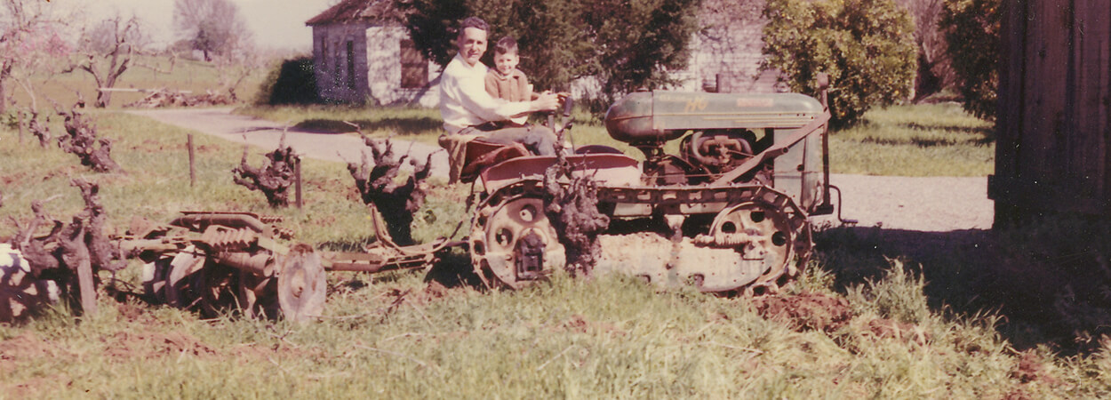 Vintage photo of Charles and John Bacigalupi on a tractor circa 1963.